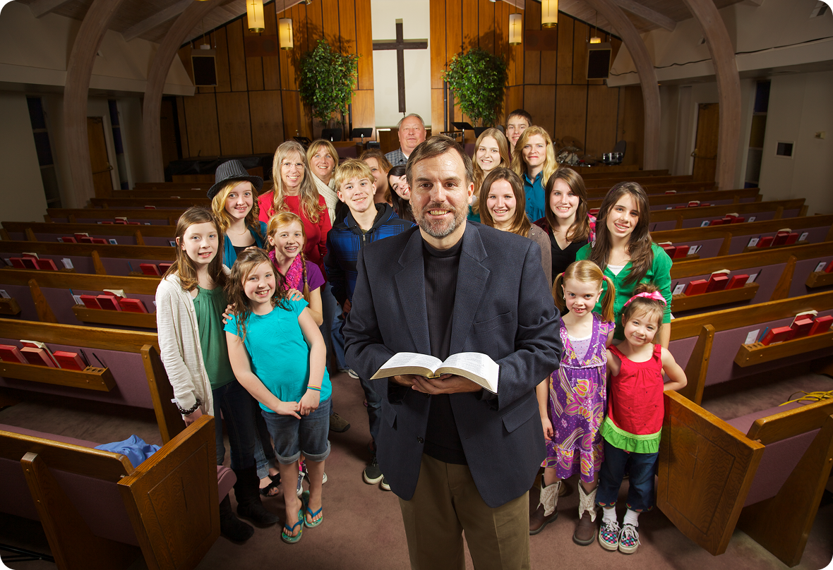 Pastor with congregation inside a church.