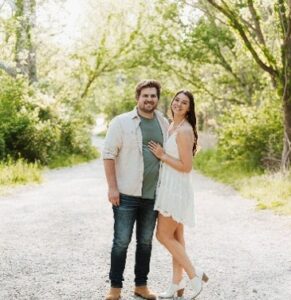 Couple posing together on a scenic path.